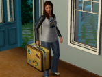 A woman walks in through the door holding a suitcase.